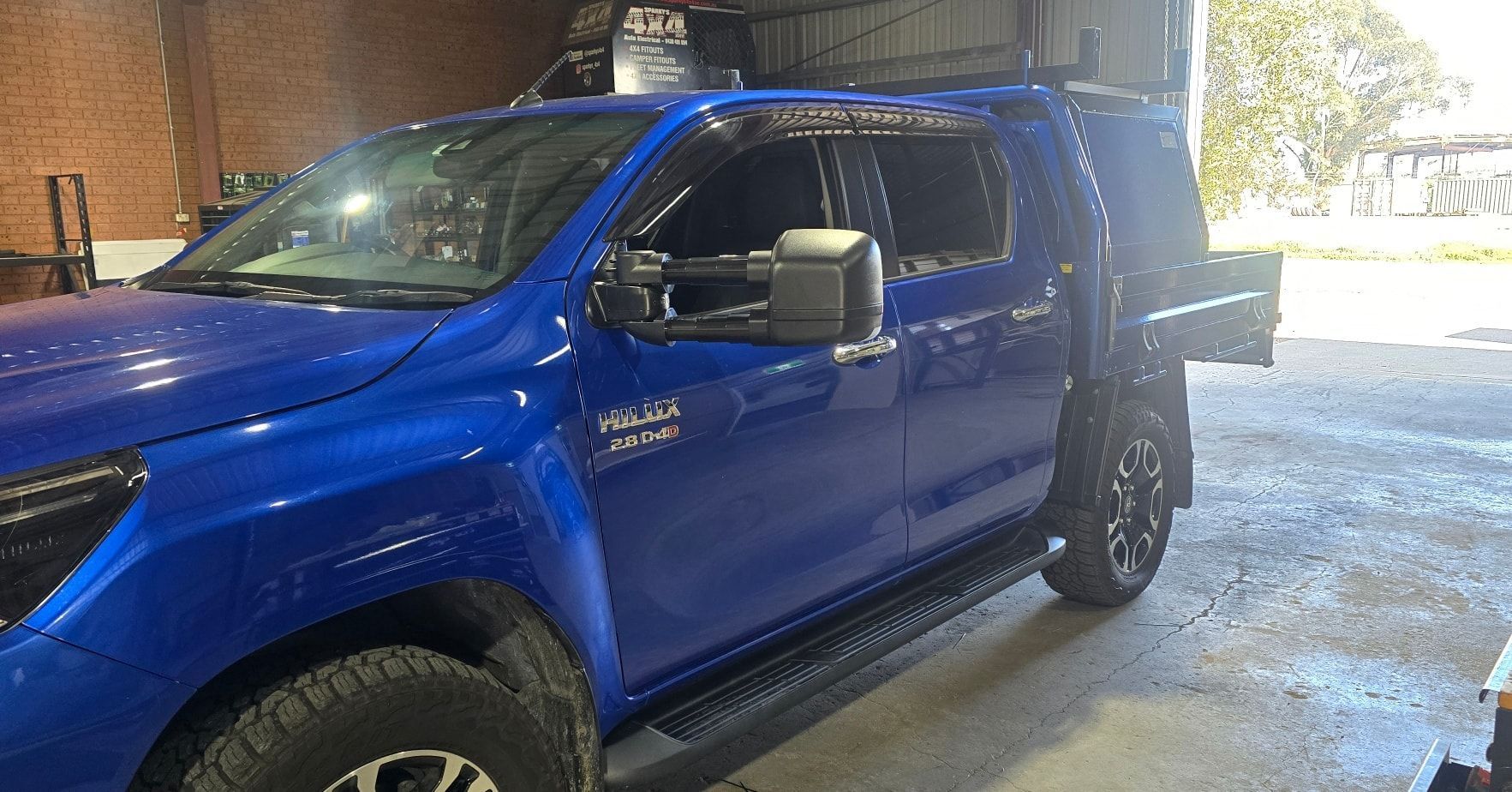 Blue Pickup Truck Parked in A Garage, with A Black Flatbed and Side Steps — Sparky's 4x4 In Gunnedah, NSW