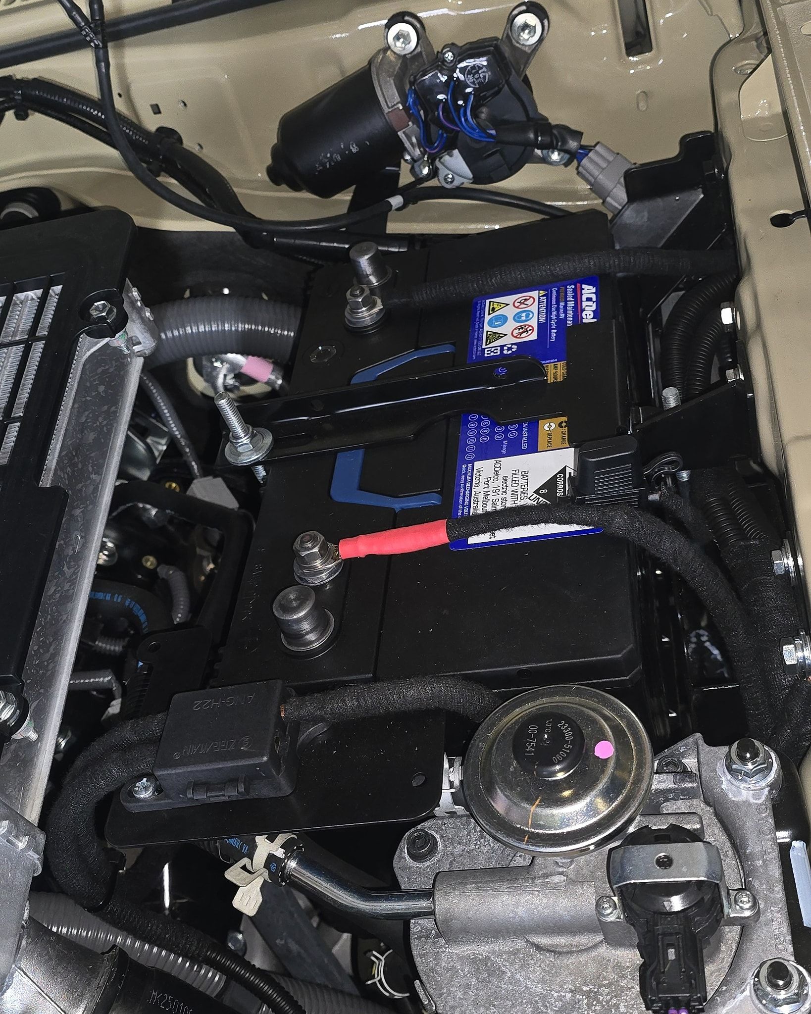 Car Battery in A Black Compartment, with Red and Black Terminals — Sparky's 4x4 In Taminda, NSW