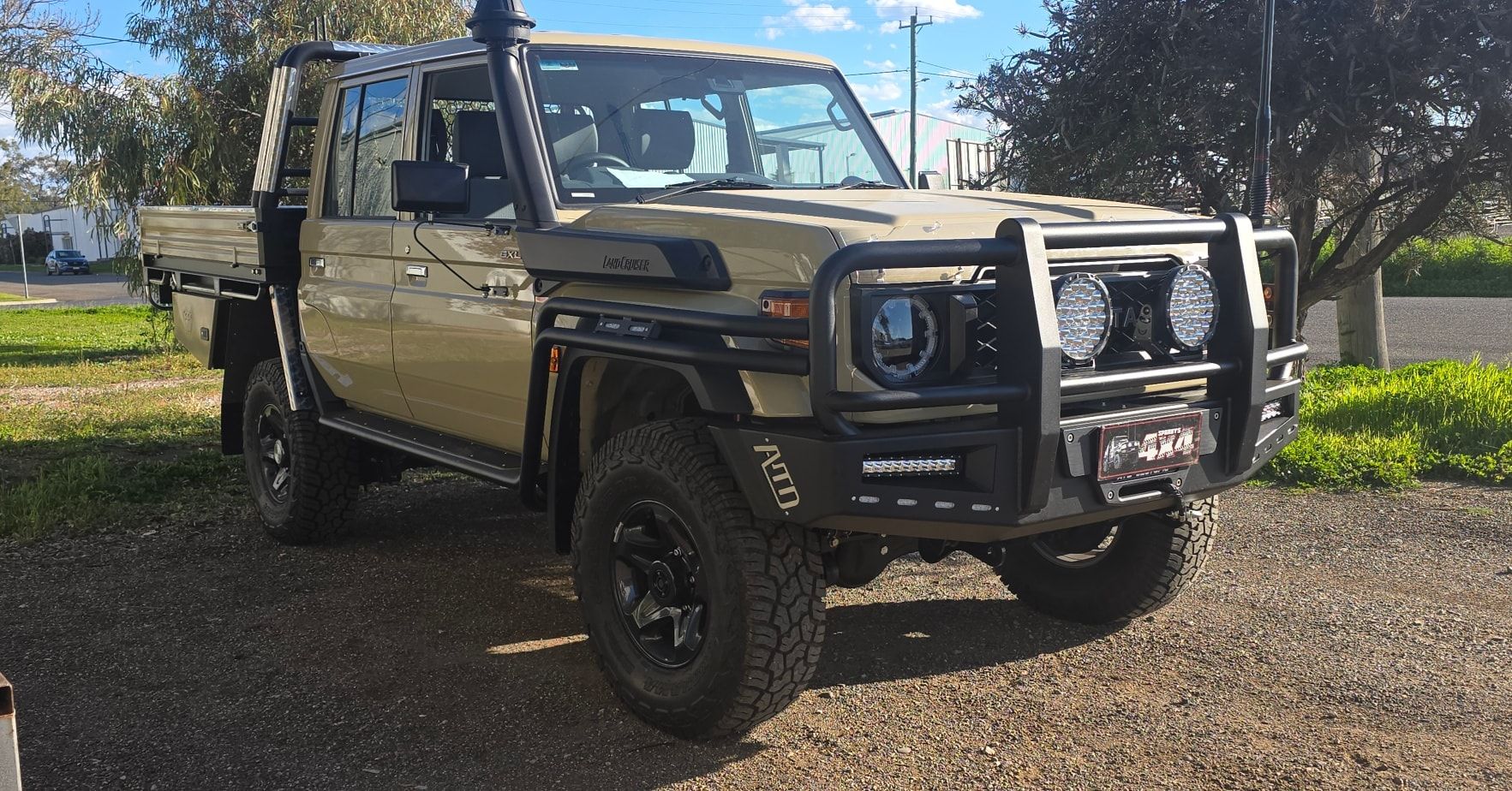 Tan Toyota Land Cruiser Pickup Truck with Black Bull Bar and Off-Road Tires — Sparky's 4x4 In Taminda, NSW