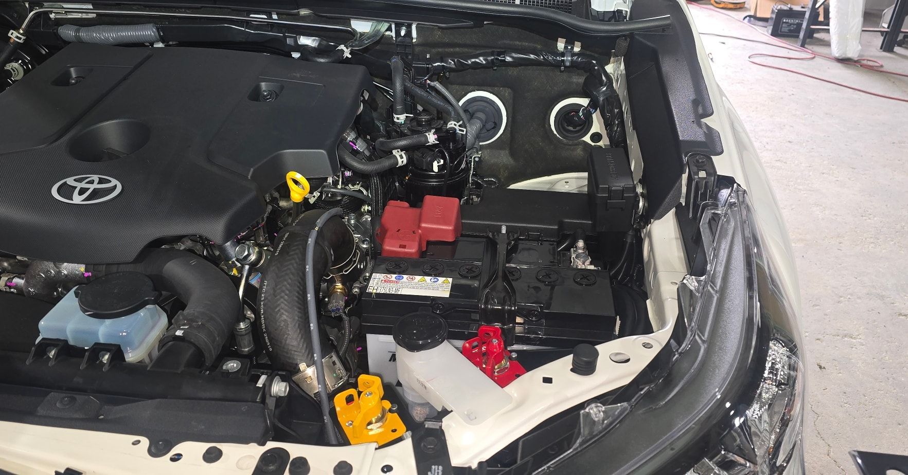 Engine Bay of A Toyota Truck with A Black Engine, Battery — Sparky's 4x4 In Gunnedah, NSW