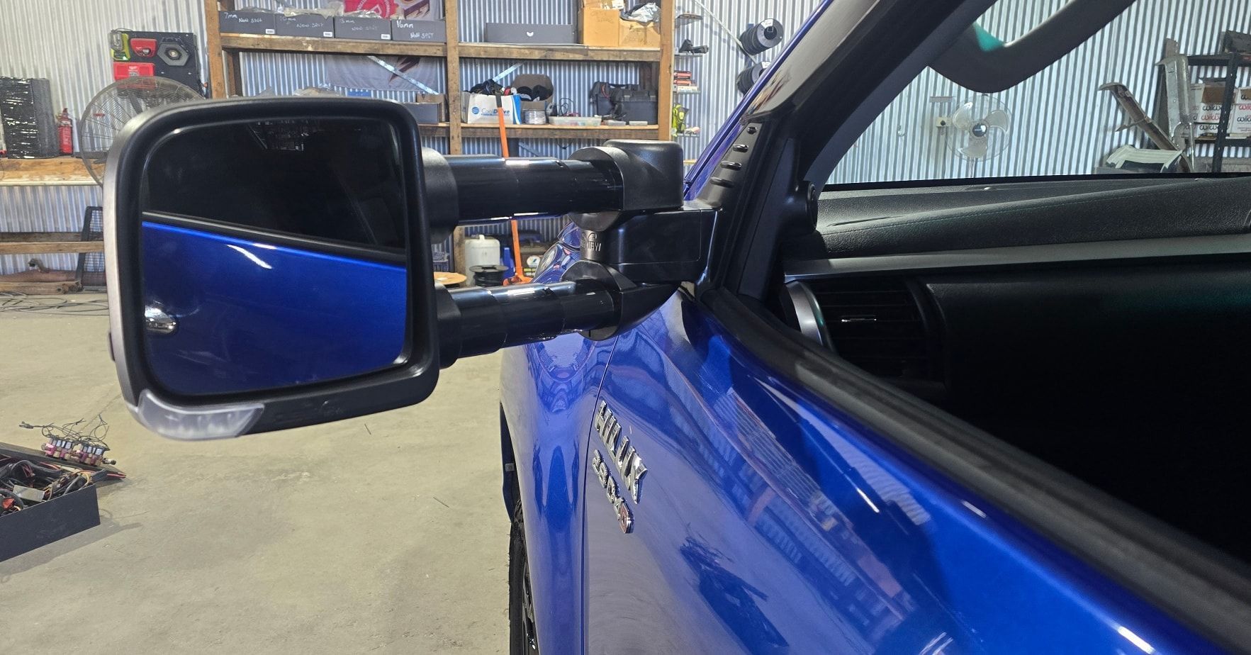 Blue Truck's Side Mirror Extended Outward in A Garage — Sparky's 4x4 In Taminda, NSW