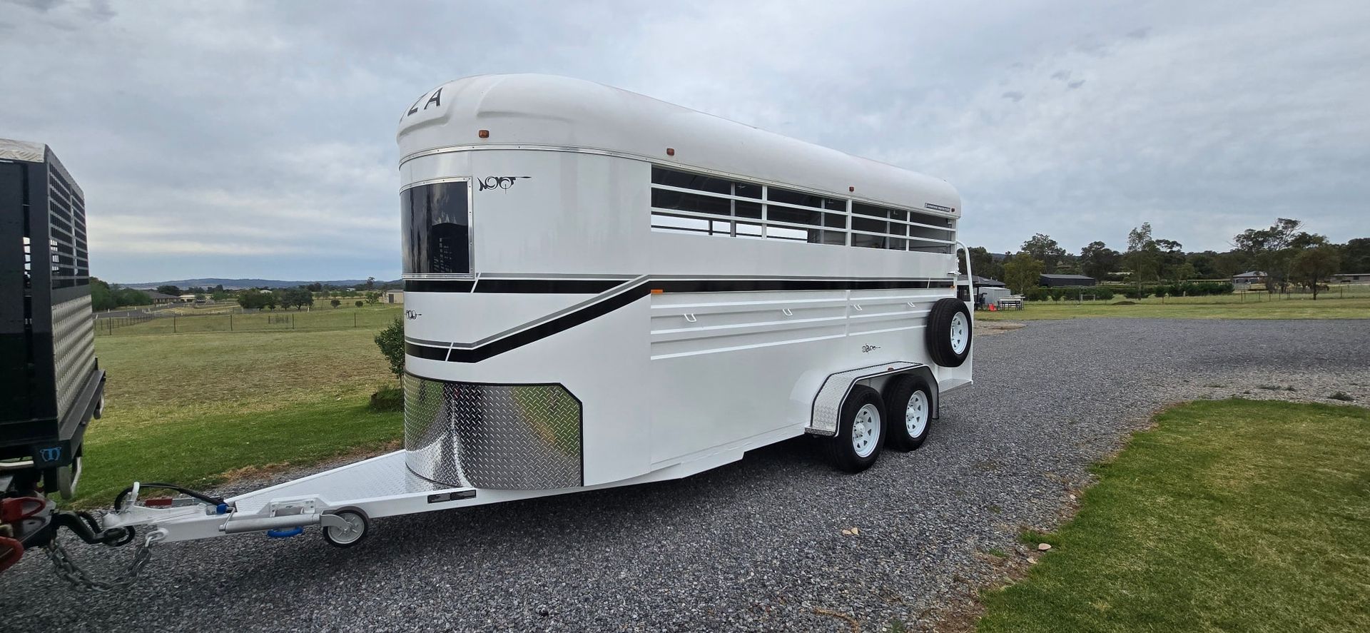 White Horse Trailer Parked on Gravel, Under a Cloudy Sky — Sparky's 4x4 In Taminda, NSW
