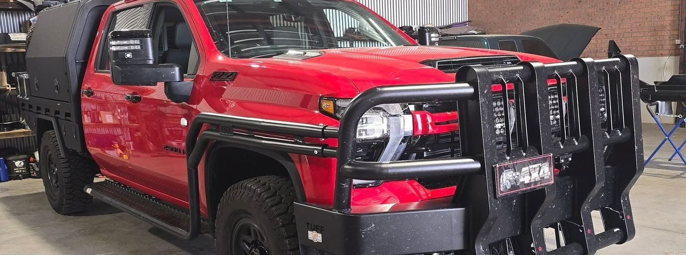 A Red Truck With a Black Bumper is Parked in a Garage — Sparky's 4x4 In Taminda, NSW