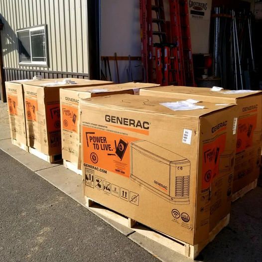 Boxes of Generac portable generators stacked on a loading dock outside a warehouse.