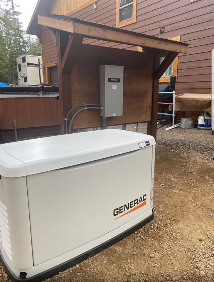 White Generac generator beside a house’s wooden shelter on a gravel yard