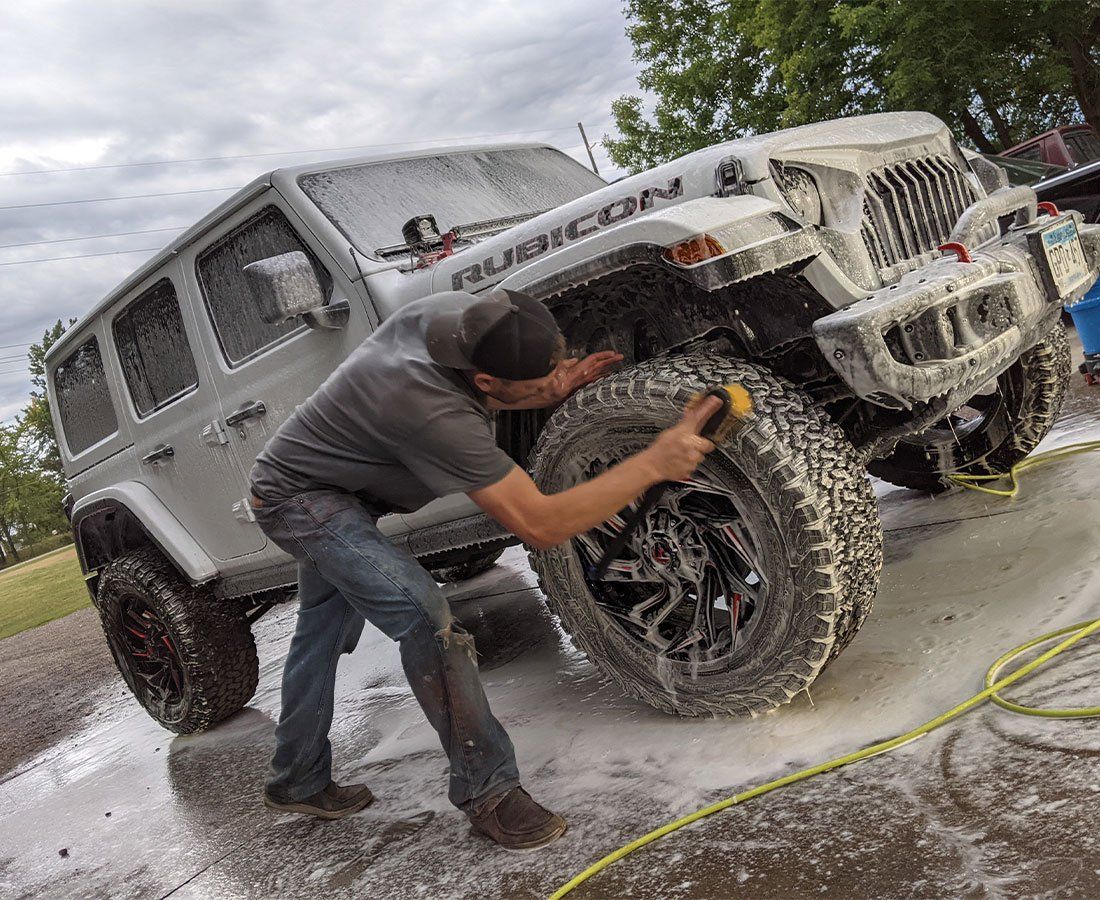 A man doing car detailing