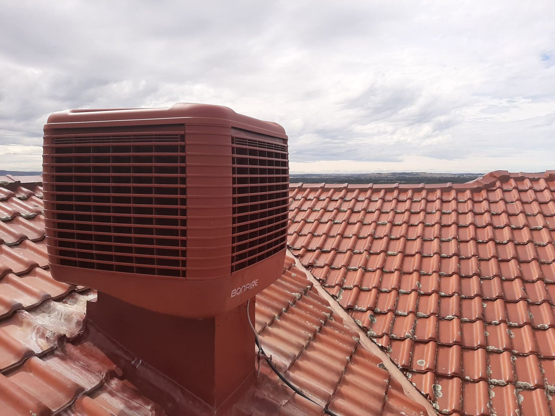 An Airconditioning Vent On A Tiled Roof — Craig Stewart Electrical in East Wagga Wagga, NSW