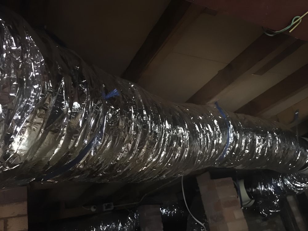 Flexible Metallic Ductwork in a Crawl Space, Secured to Wooden Beams — Craig Stewart Electrical in East Wagga Wagga, NSW