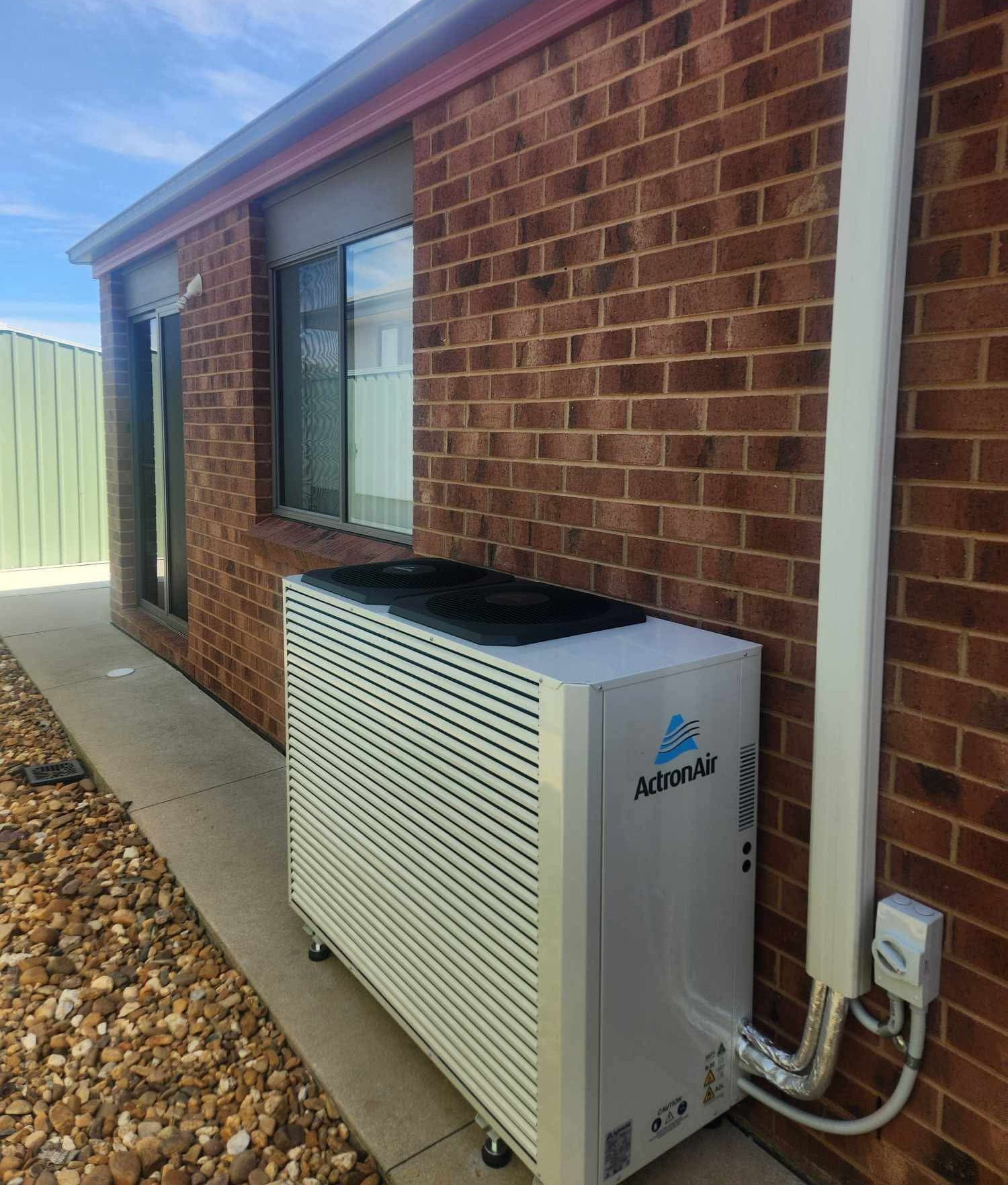 Black Ceiling Beams With Overhead Lighting and an Air Conditioning Unit — Craig Stewart Electrical in East Wagga Wagga, NSW