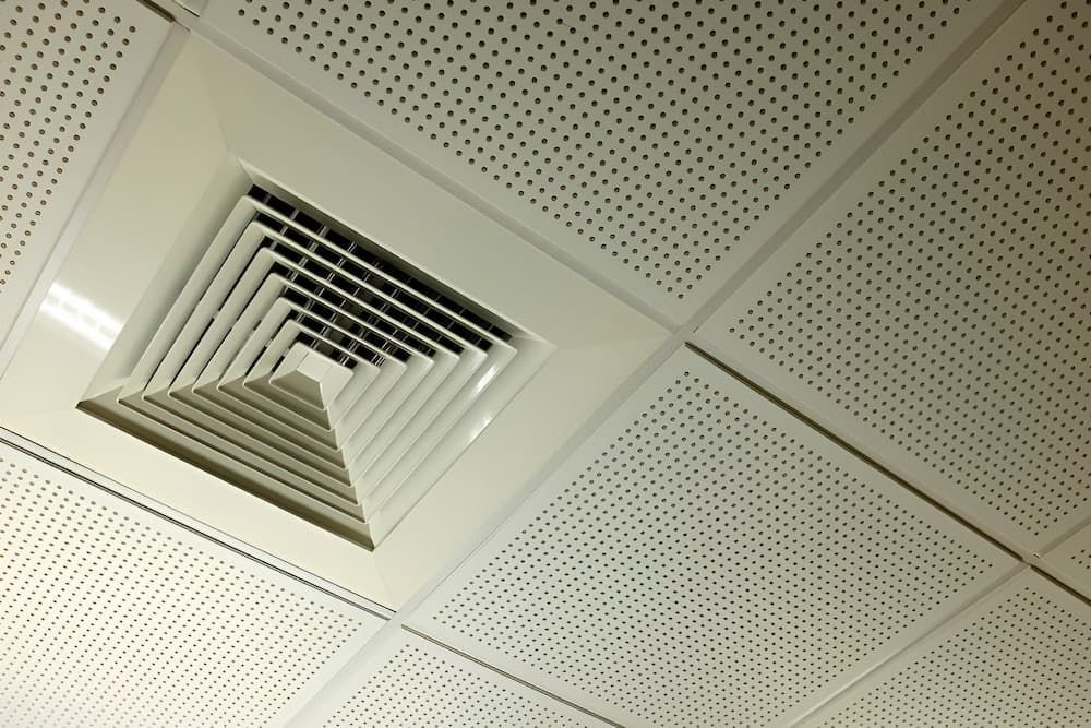 White Ceiling With a Square Air Vent and Perforated Tiles — Craig Stewart Electrical in East Wagga Wagga, NSW