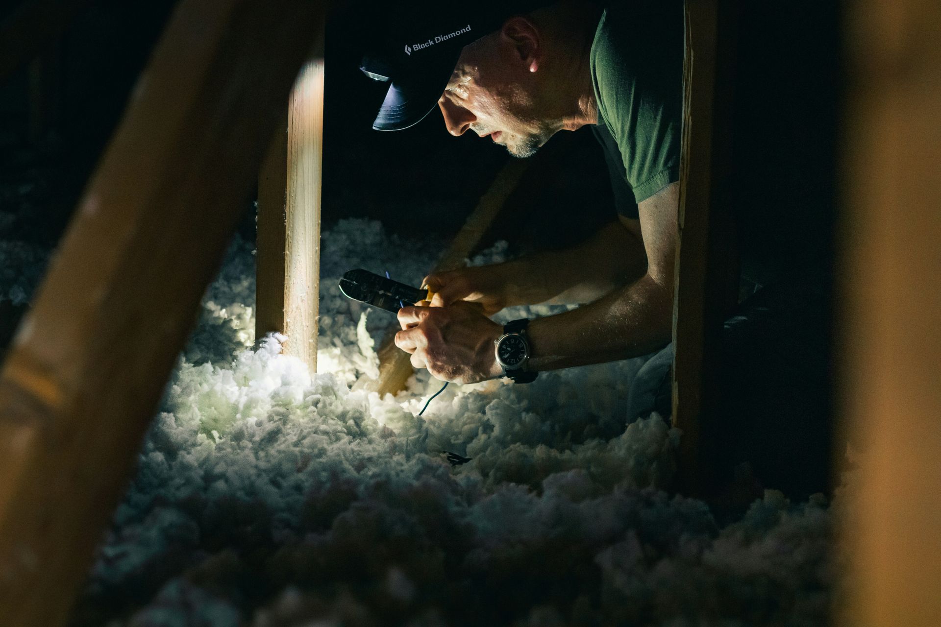 Contractor installing blown-in insulation in a home attic