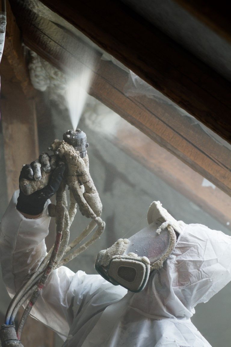 Spray foam insulation being applied in a home attic