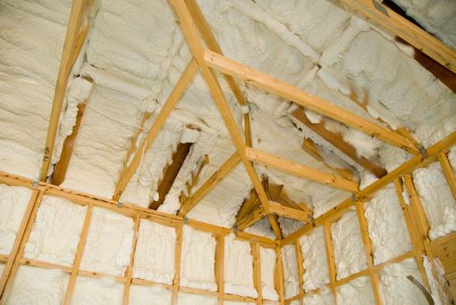 Attic insulation installed along the roofline in a home