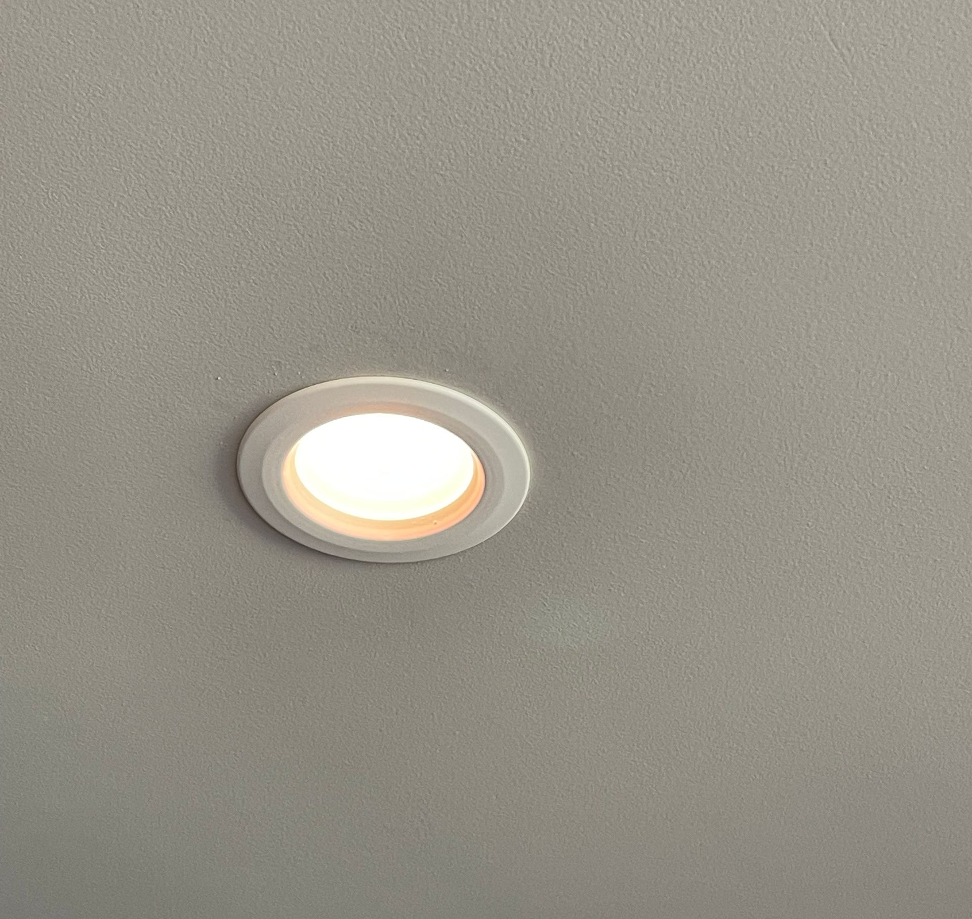 a person is holding a light bulb in their hand .