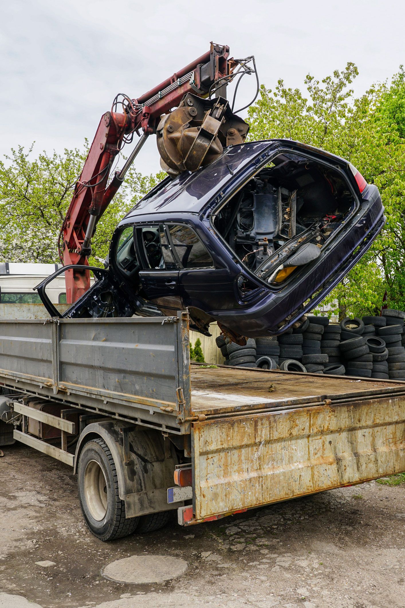 A crane is lifting a car from the back of a truck. A crane is lifting a car from the back of a truck.