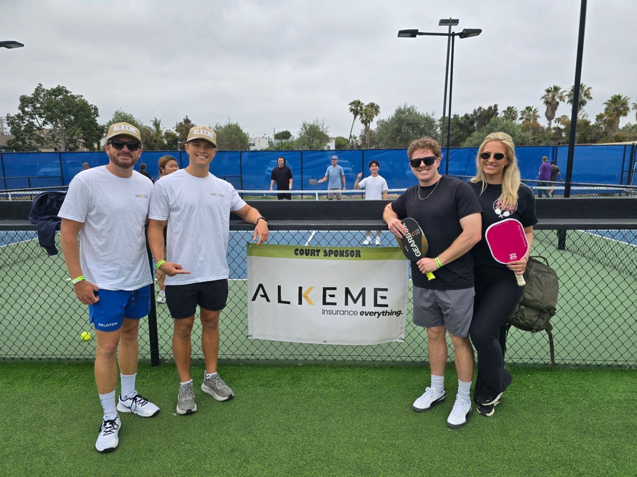 PWI 2026 Pickleball Tournament -four players stand in front of Alkeme sign