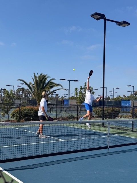 PWI 2026 Pickleball Tournament - playing pickleball. Reaching for a high shot
