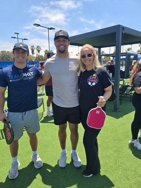 PWI 2026 Pickleball Tournament - two men and one woman smiling