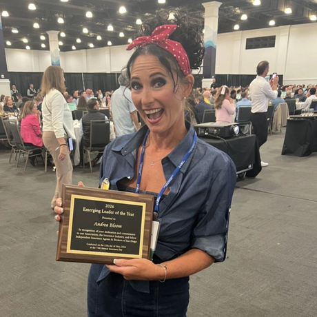 Andrea Bloom is holding the 2026 Emerging Leader of the Year plaque. 