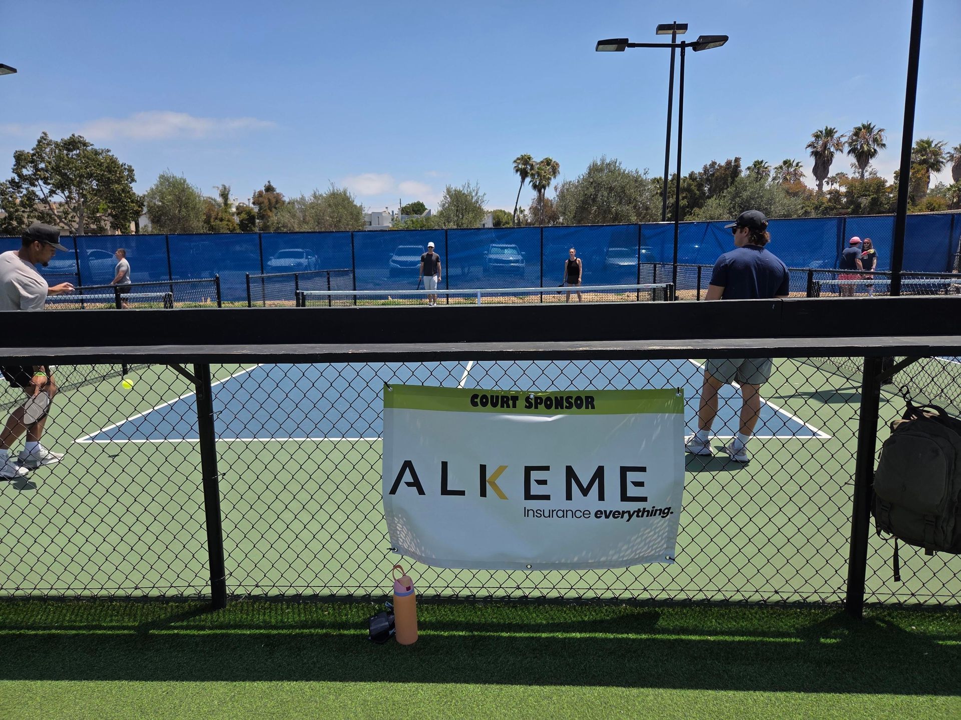 PWI 2026 Pickleball Tournament -playing pickleball on a court sponsored by Alkeme