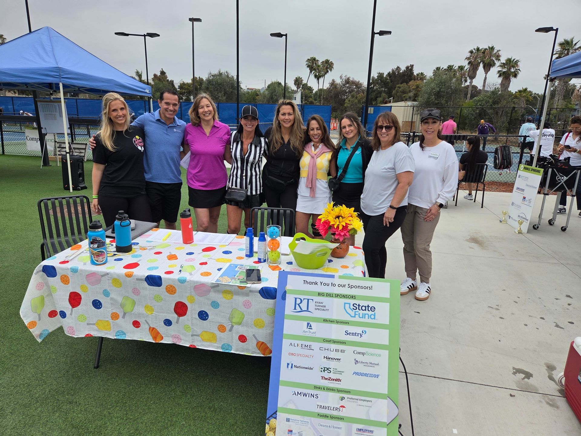 PWI 2026 Pickleball Tournament - group stand behind welcome table