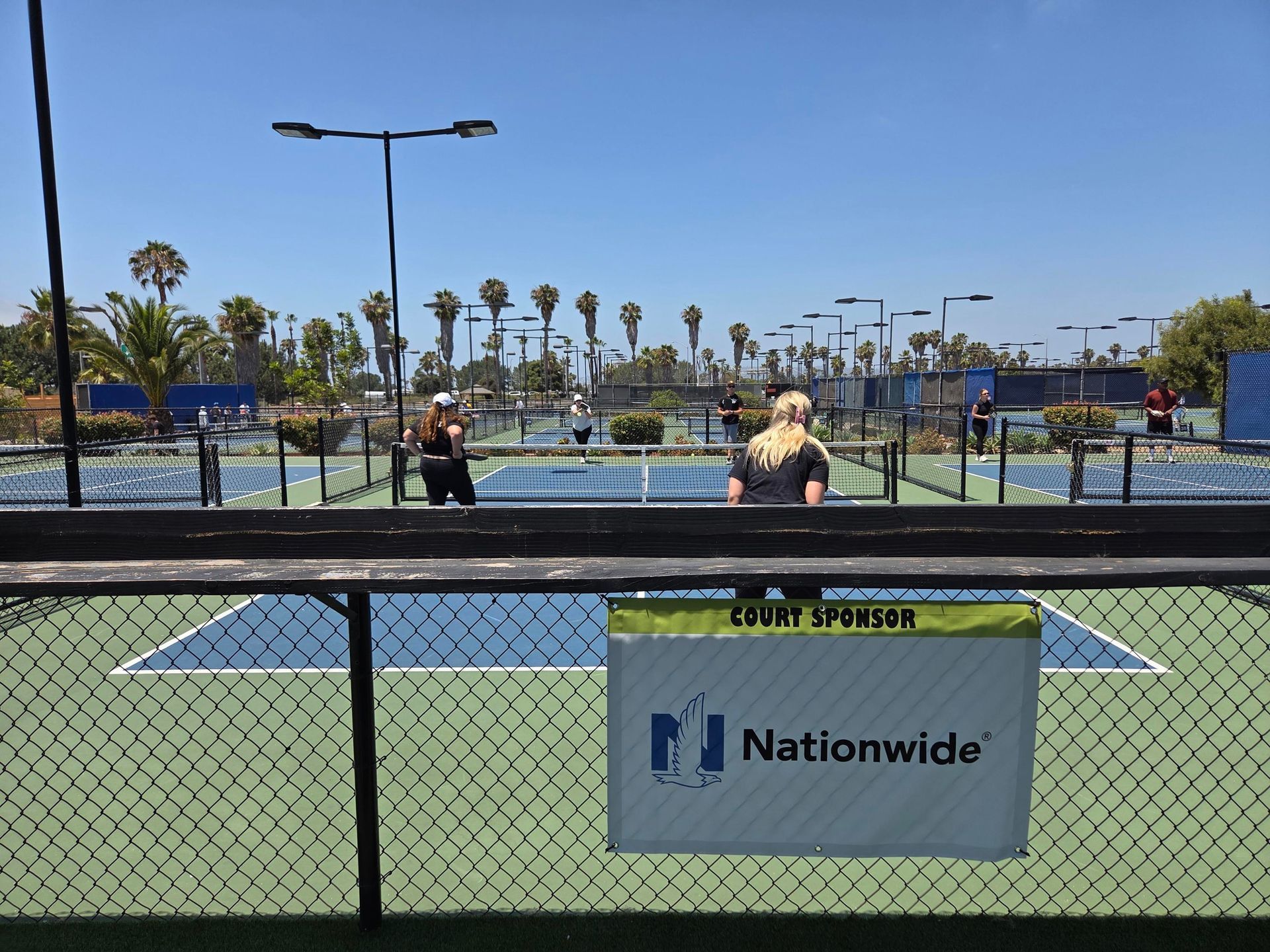 PWI 2026 Pickleball Tournament - playing pickleball on a court sponsored by Nationwide