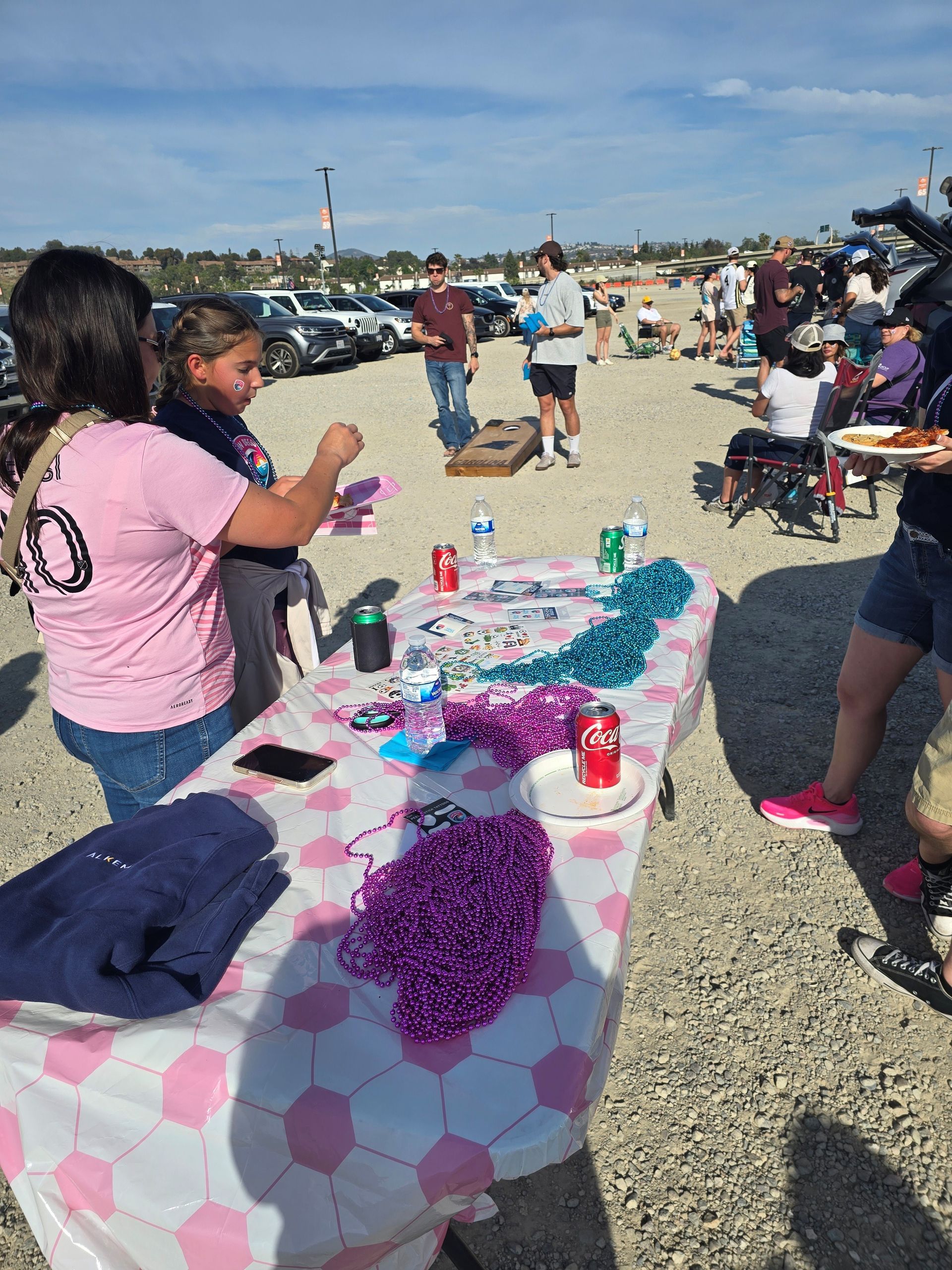 2026 Waves Soccer Game and Tailgate - Members playing corn hole 