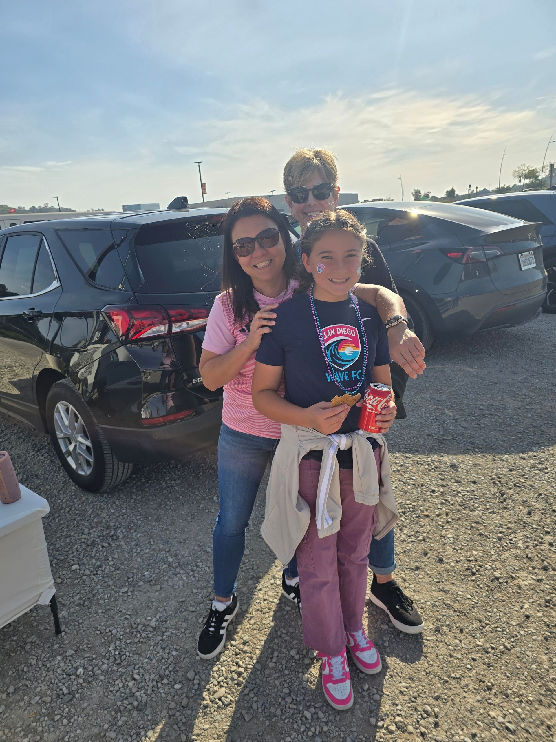 2026 Waves Soccer Game and Tailgate - Two members and a child tailgating