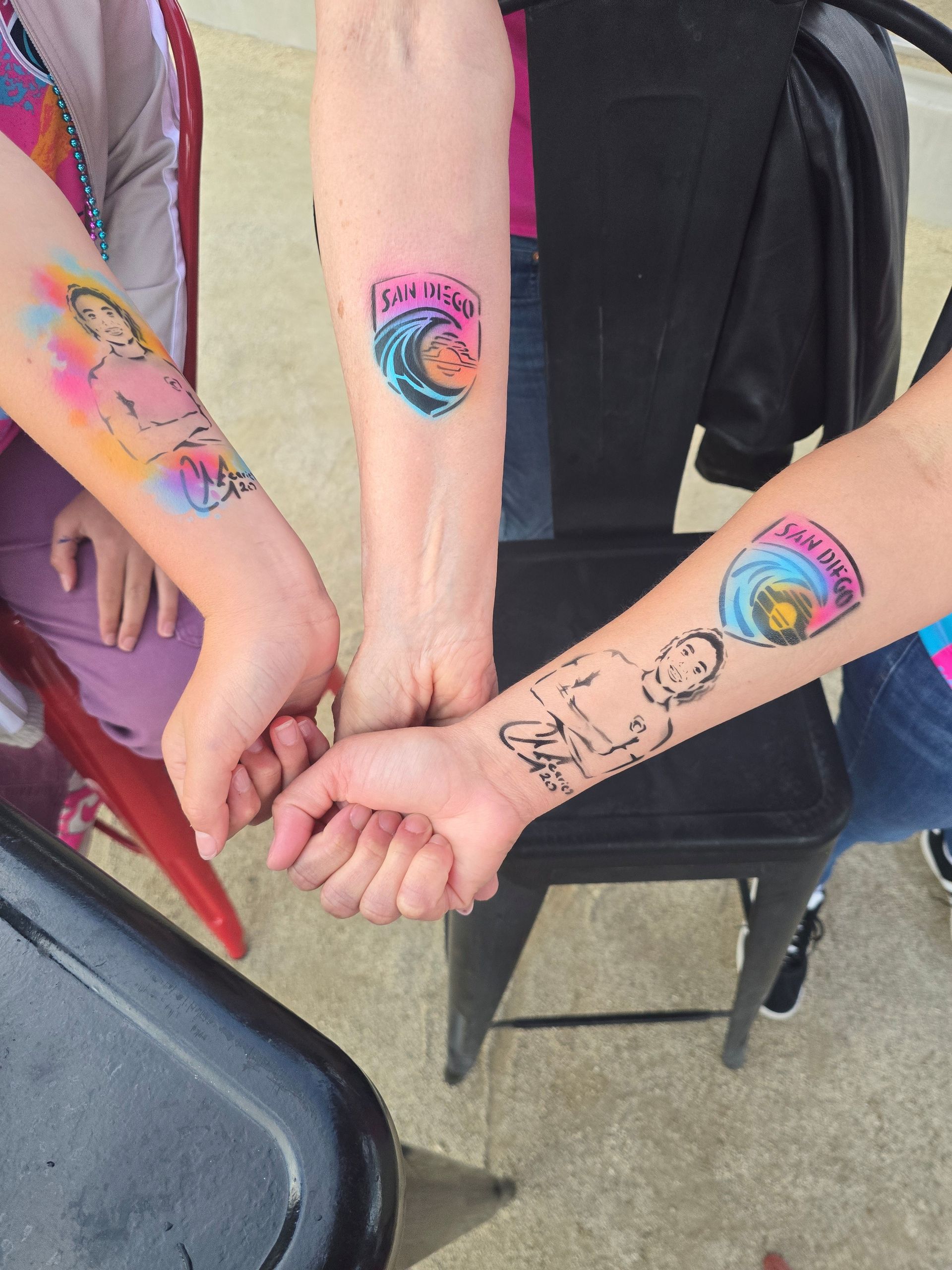 2026 Waves Soccer Game and Tailgate - 3 arms showing temporary Waves tattoos 