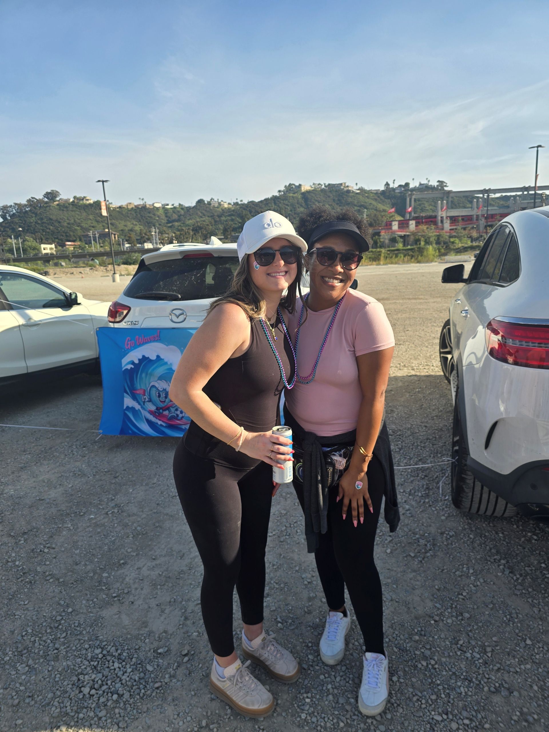 2026 Waves Soccer Game and Tailgate - Two members standing in the parking lot for the tailgate
