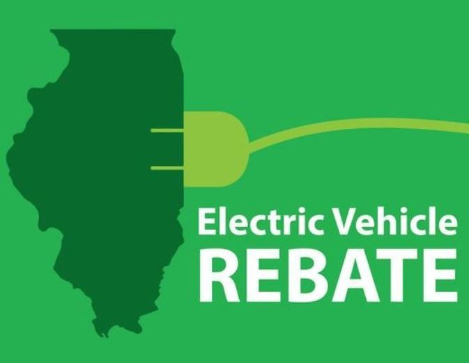 A green sign that says electric vehicle rebate