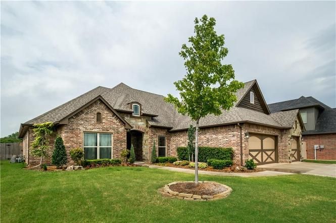 a large brick house with a tree in front of it