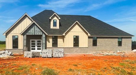 a large house is being built on a dirt field