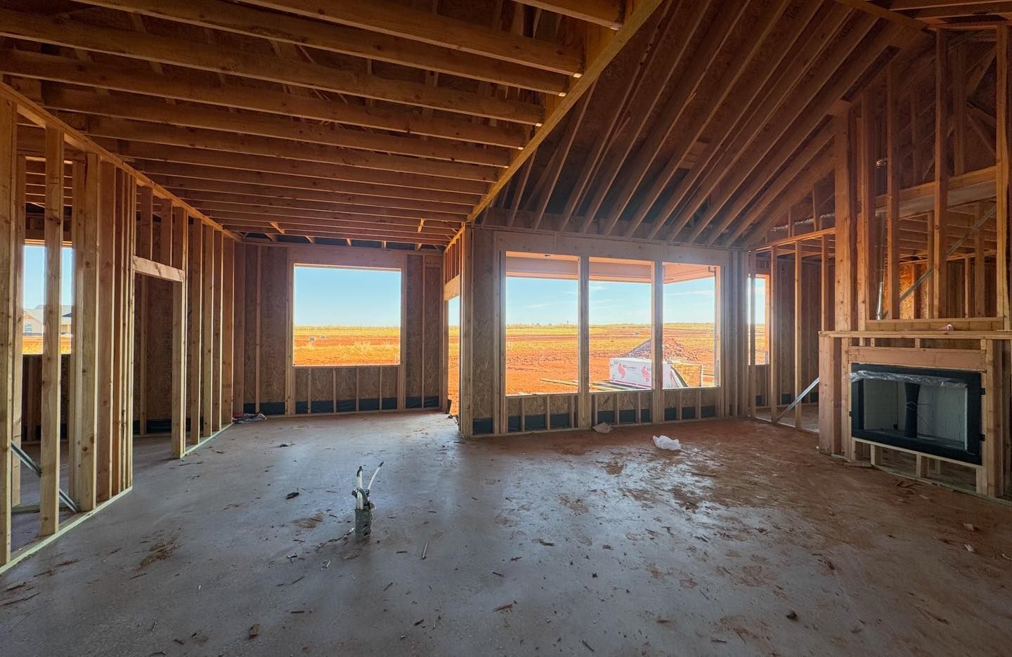 a large empty room in a house under construction