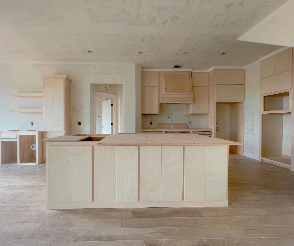 an empty kitchen with a large island in the middle