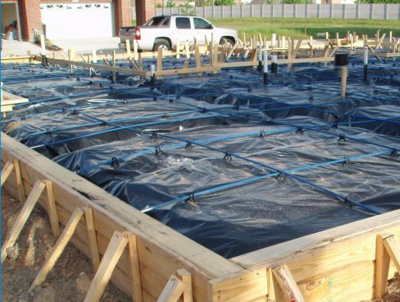 A construction site with a lot of steel bars on the ground.
