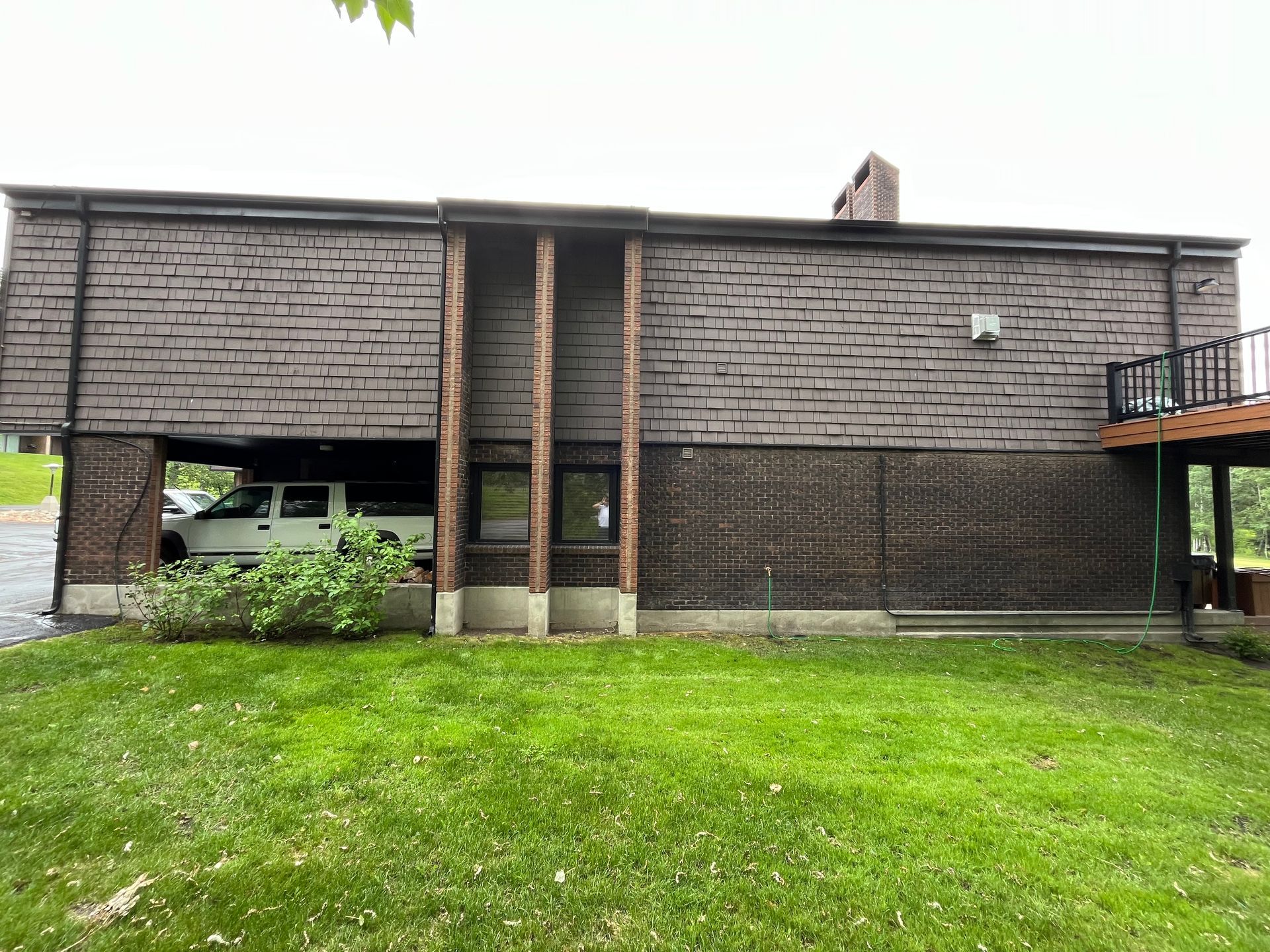 A large brick building with a car parked underneath it.