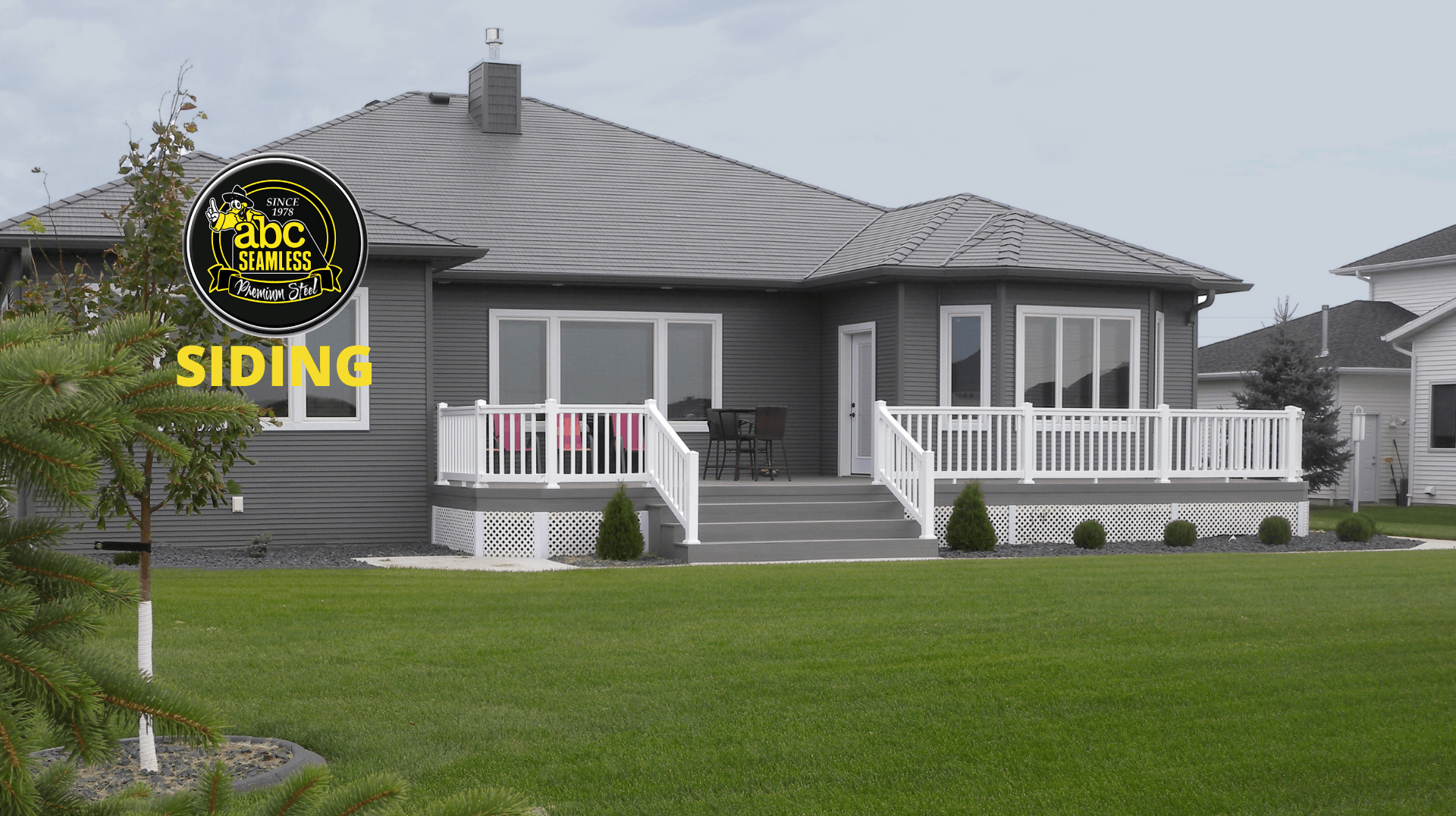 A house with a sign in front of it that says siding