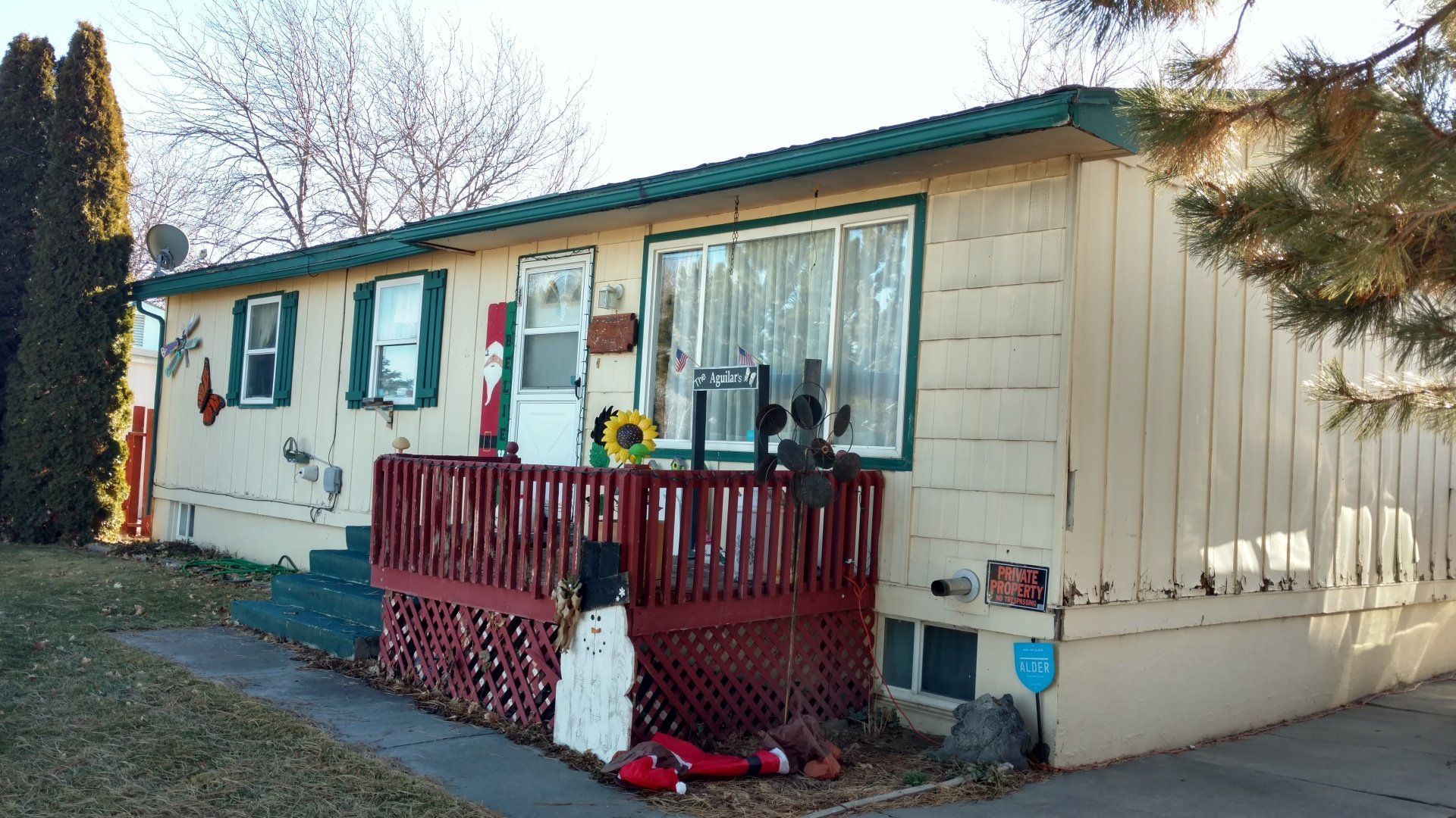 A mobile home with a christmas decoration on the porch