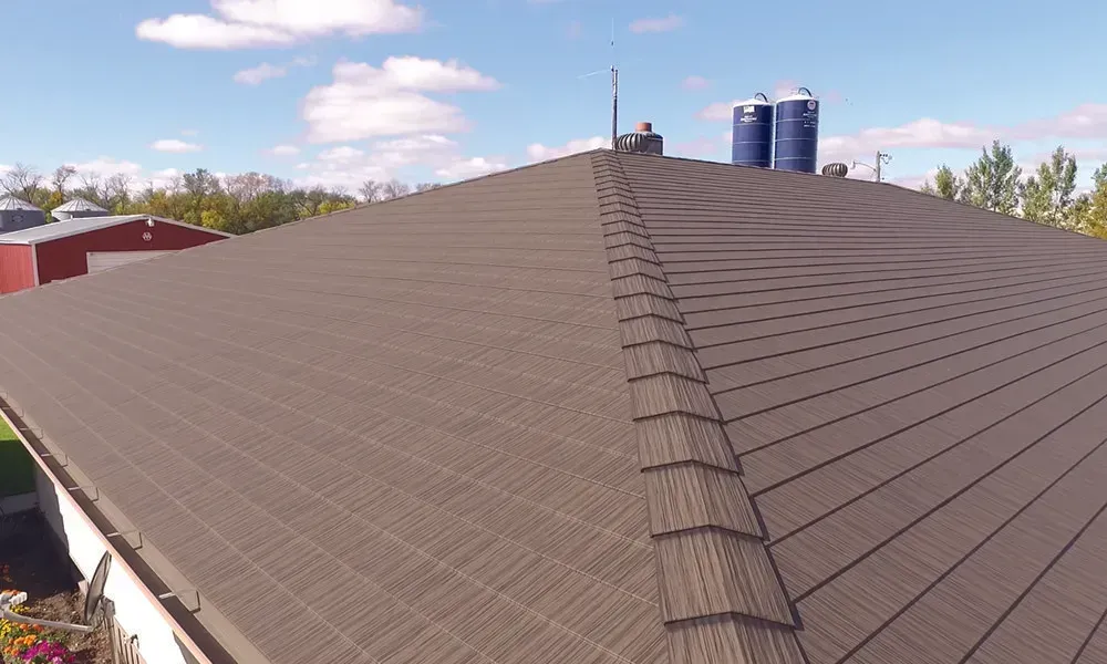 An aerial view of a roof with a silo in the background.