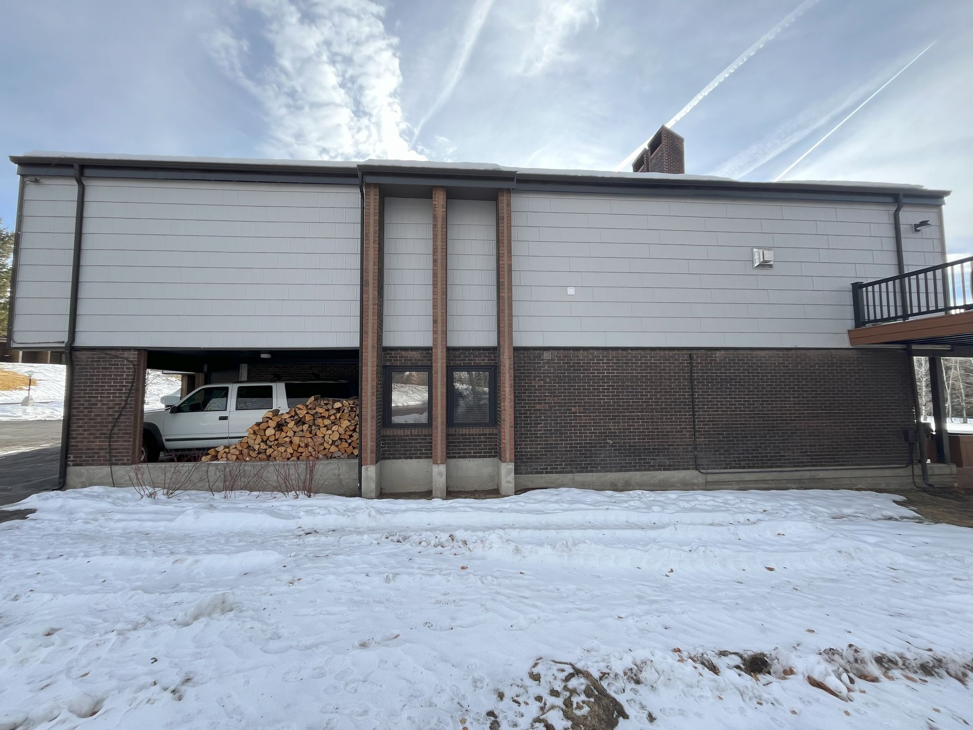 A white truck is parked in the garage of a house