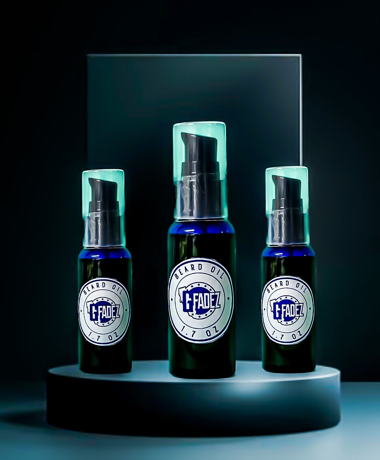 Three blue cosmetic bottles with pump tops on a dark display pedestal