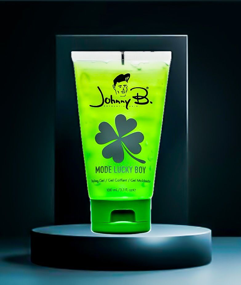 Neon green lotion tube with clover logo on a round pedestal against a dark background