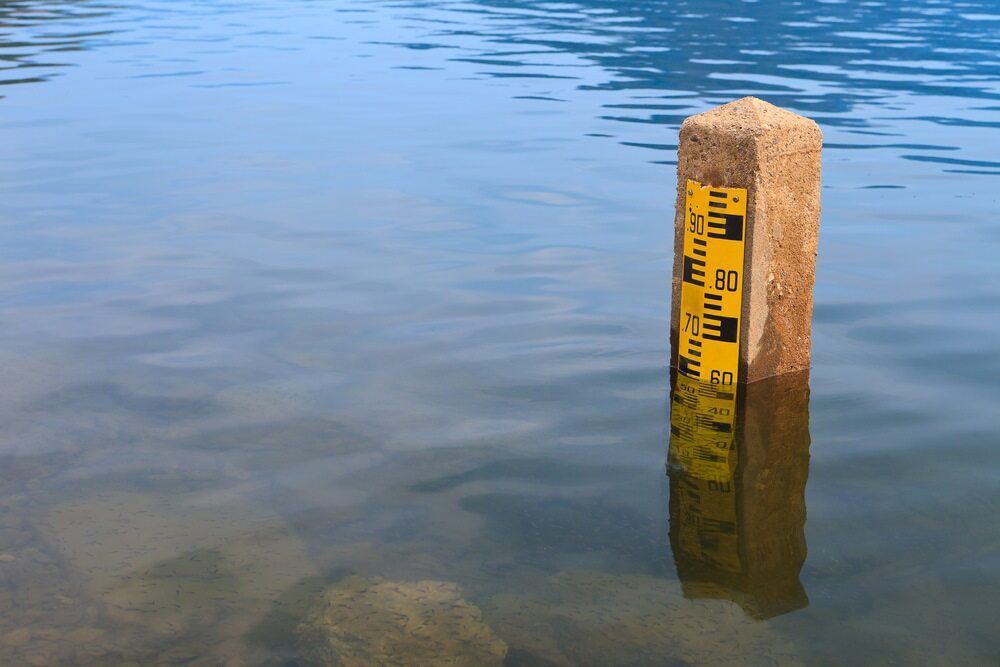 A Yellow Pole In The Middle Of A Body Of Water — A2Z Property Services In Kybong, QLD