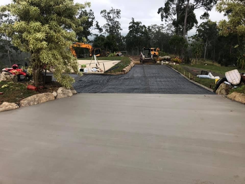 A Concrete Driveway is Being Built in a Residential Area — A2Z Property Services In Kybong, QLD