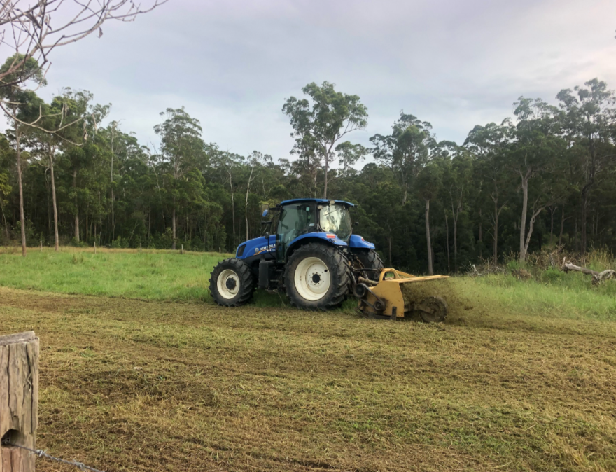 A Tractor Clearing Out A Field To Make A Driveway— A2Z Property Services In Kybong, QLD