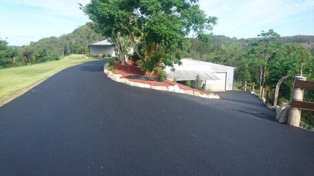 A Road With A House On The Side Of It And A Tree On The Side Of It — A2Z Property Services In Kybong, QLD