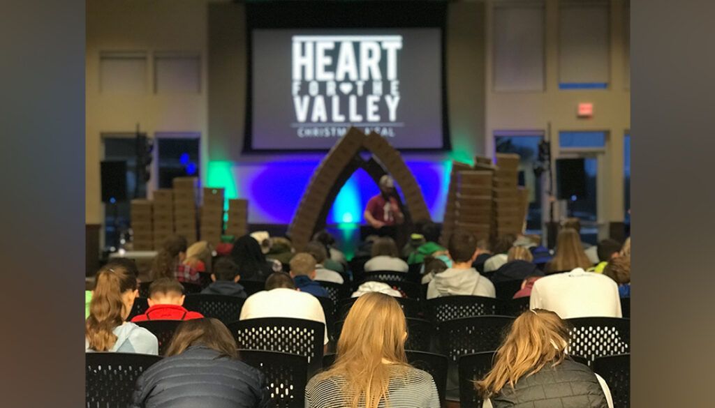 hftvblogfeatured Audience in chairs facing a stage with a