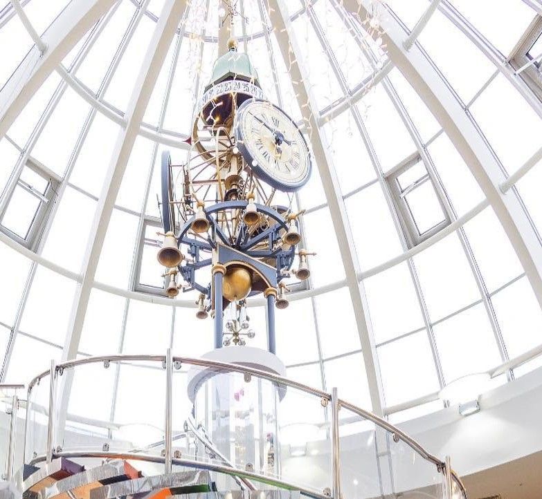 Ornate mechanical dome ceiling clock viewed from below