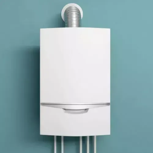 A white gas boiler is hanging on a blue wall.